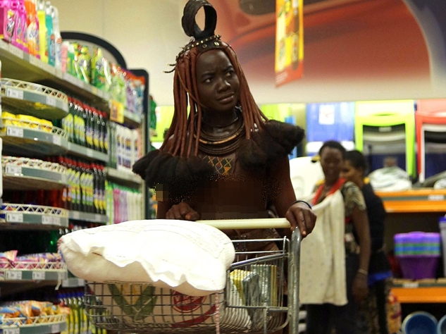 African Tribeswoman Is Pictured In Supermarket Wearing Goat Skins And Mud For Sunscreen